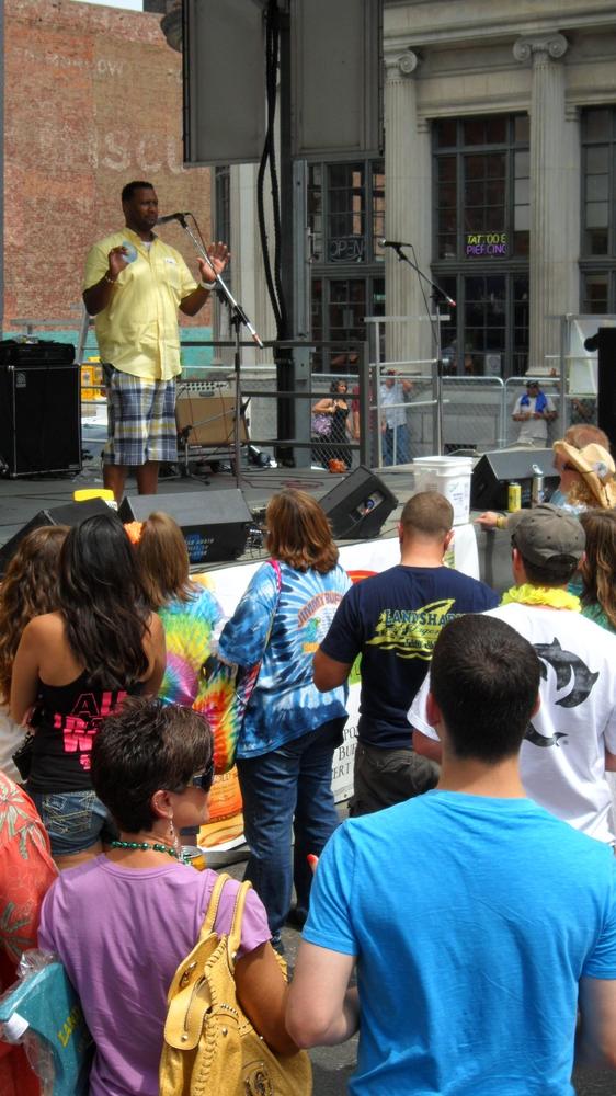 MC on stage in front of a festival crowd